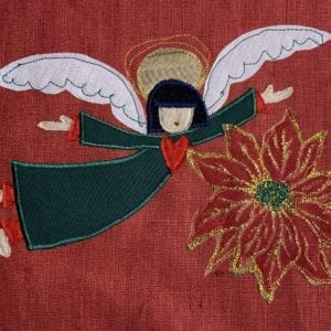 Angel: green robe on red linen with poinsettia